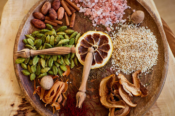 Close-up of exotic Spices arranged on a round cutting board, resembling a clock