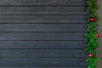 Background Happy New Year. Copy space. Spruce branches with Christmas balls at the right of the photo