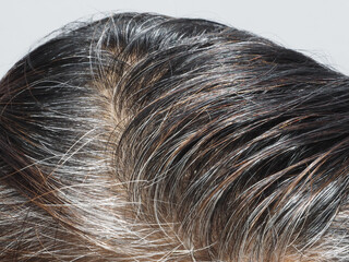 A close-up of grey hair roots.   People, beauty concept.