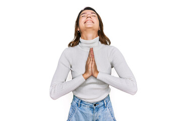 Young caucasian girl wearing casual clothes begging and praying with hands together with hope...