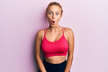 Beautiful caucasian woman wearing sportswear afraid and shocked with surprise expression, fear and excited face.