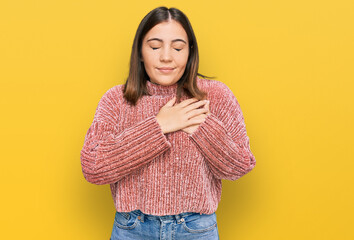 Young beautiful woman wearing casual clothes smiling with hands on chest with closed eyes and grateful gesture on face. health concept.