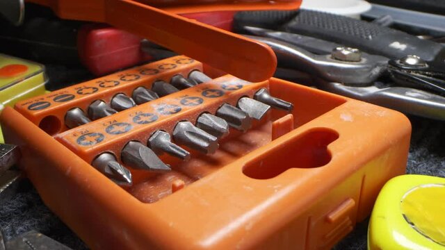 extremely close-up, detailed. drill bits in orange toolbox.