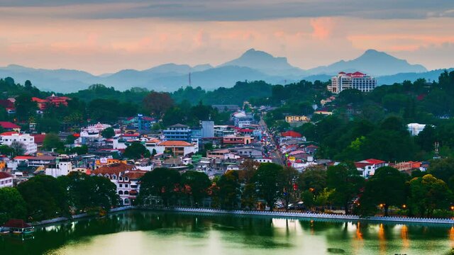 Kandy, Sri Lanka. Lake in Kandy. Time-lapse of a sunset over the former capital of Sri Lanka. Panoramic view at night with car light trails
