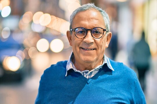 Senior grey-haired man smiling happy standing at the city.