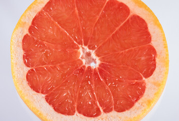 round slice of a grapefruit isolated on white background. Round slice of fresh fruit.