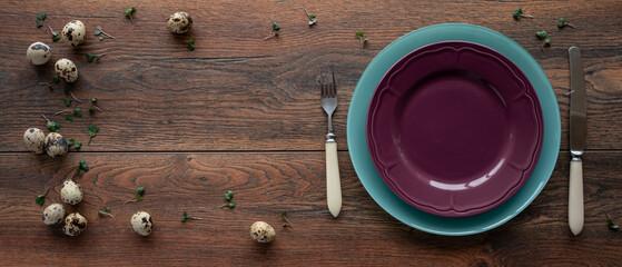 Food ingredients. Вackground. Quail eggs, micro greens. Plates, fork and knife. Meal setting
