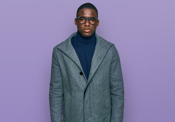Young african american man wearing business clothes and glasses looking sleepy and tired, exhausted for fatigue and hangover, lazy eyes in the morning.