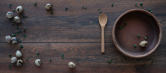 Food ingredients. Вackground. Quail eggs, micro greens. Clay plates, wooden spoon. Meal setting