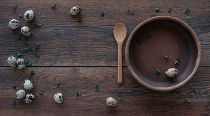 Food ingredients. Вackground. Quail eggs, micro greens. Clay plates, wooden spoon. Meal setting