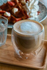 top view of vanilla hot latte on wood plate