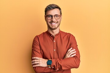 Handsome caucasian man wearing casual clothes and glasses happy face smiling with crossed arms...