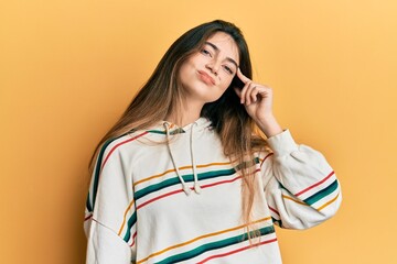 Young caucasian woman wearing casual clothes pointing unhappy to pimple on forehead, ugly infection...