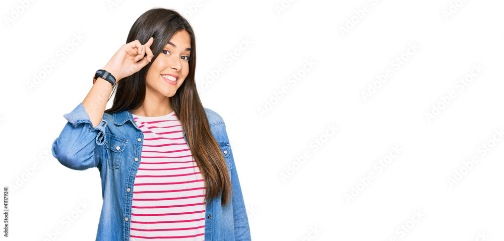 Canvas Prints Young brunette woman wearing casual clothes smiling pointing to head with one finger, great idea or thought, good memory