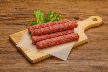 Raw beef sausages with spices