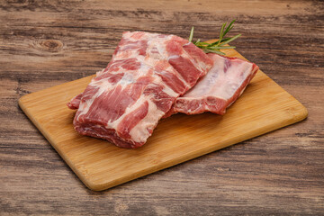 Raw pork ribs served rosemary