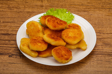 Fried chicken nuggets served salad leaves