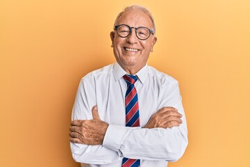 Senior caucasian man wearing business clothes happy face smiling with crossed arms looking at the camera. positive person.