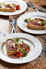Easter meat roll, meatloaf for Easter dinner. Beautifully decorated catering banquet table with different food snacks and appetizers