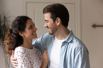 Strong and happy marriage. Affectionate caring millennial husband and wife cuddling supporting...