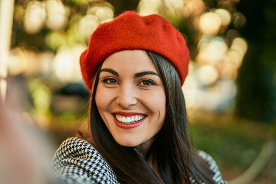 Young hispanic woman smiling happy making selfie by the camera at the city.