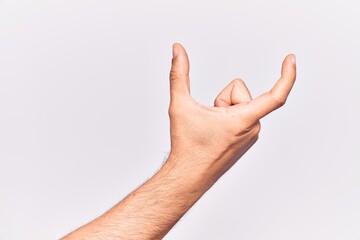 Close up of hand of young caucasian man over isolated background picking and taking invisible thing, holding object with fingers showing space