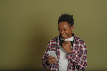 Fototapeta premium young african american guy talking on the phone on a green background