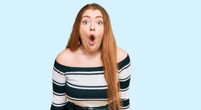 Young beautiful redhead woman wearing elegant clothes afraid and shocked with surprise expression, fear and excited face.