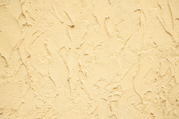 rustic beige textured wall background surface with plaster divorces and empty copy space for your text