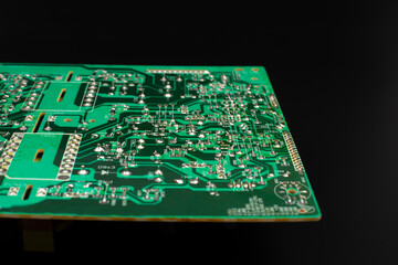 Green circuit board close up on black background