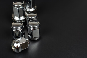 chrome wheel nuts group on black background