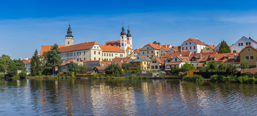 Panorama of the castle and old houses reflected in the lake in Telc, Czech Republic