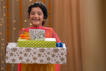 beautiful sister standing with presents in her hand	
