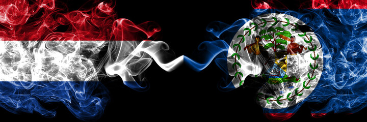 Netherlands vs Belize, Belizean smoky mystic flags placed side by side. Thick colored silky abstract smoke flags.