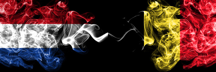 Netherlands vs Belgium, Belgian smoky mystic flags placed side by side. Thick colored silky abstract smoke flags.
