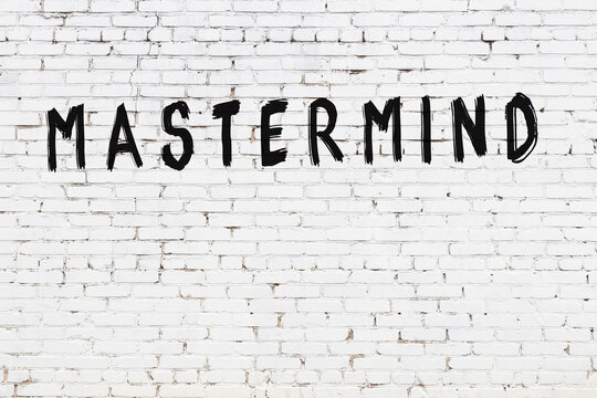 White wall with black paint inscription mastermind on it