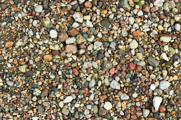 Clean small stones, nature background, outdoor daylight, summer beach. Gravel background