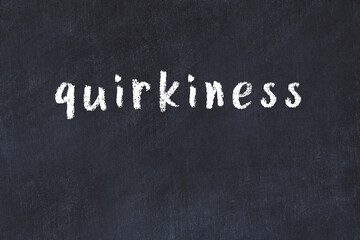 Black chalkboard with inscription quirkiness on in