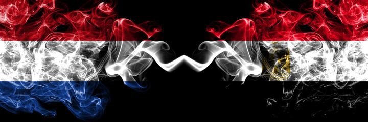 Netherlands vs Egypt, Egyptian smoky mystic flags placed side by side. Thick colored silky abstract smoke flags.
