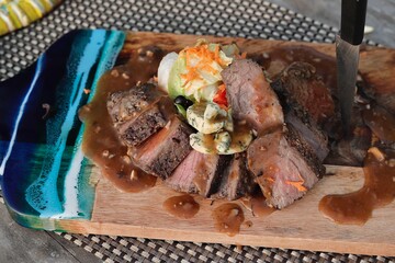 grilled steak chops on an wooden board 