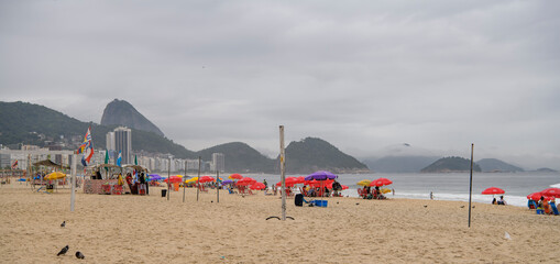Fototapeta premium Citizens swim and sunbathe on the beach of Copacabana