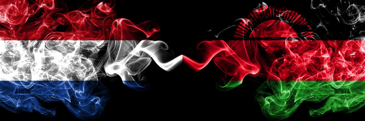 Netherlands vs Malawi smoky mystic flags placed side by side. Thick colored silky abstract smoke flags.