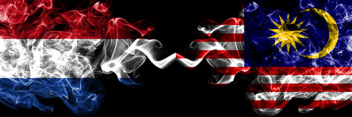 Netherlands vs Malaysia, Malaysian smoky mystic flags placed side by side. Thick colored silky abstract smoke flags.