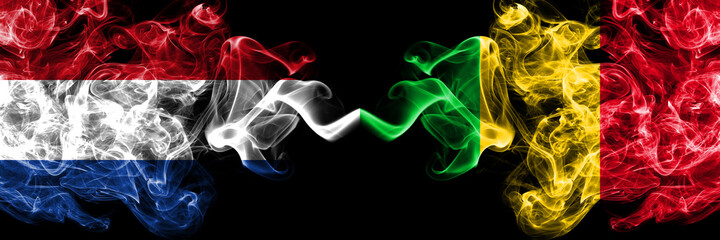 Netherlands vs Mali smoky mystic flags placed side by side. Thick colored silky abstract smoke flags.