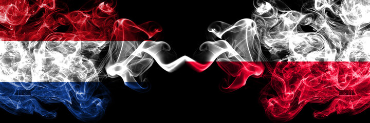 Netherlands vs Poland, Polish, Pole smoky mystic flags placed side by side. Thick colored silky abstract smoke flags.