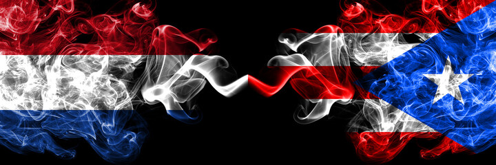 Netherlands vs Puerto Rico smoky mystic flags placed side by side. Thick colored silky abstract smoke flags.