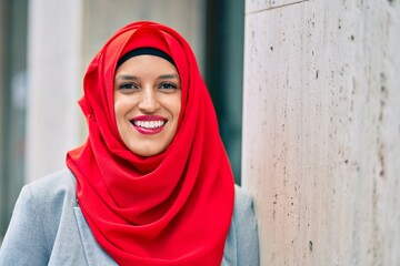 Young arab woman wearing hijab smiling happy at the city.