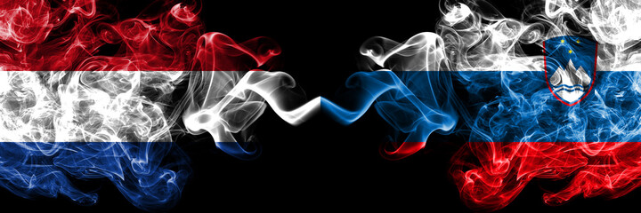 Netherlands vs Slovenia, Slovenian smoky mystic flags placed side by side. Thick colored silky abstract smoke flags.