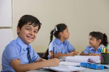 children studying in class and smiling	
