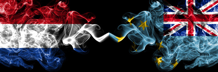 Netherlands vs Tuvalu smoky mystic flags placed side by side. Thick colored silky abstract smoke flags.